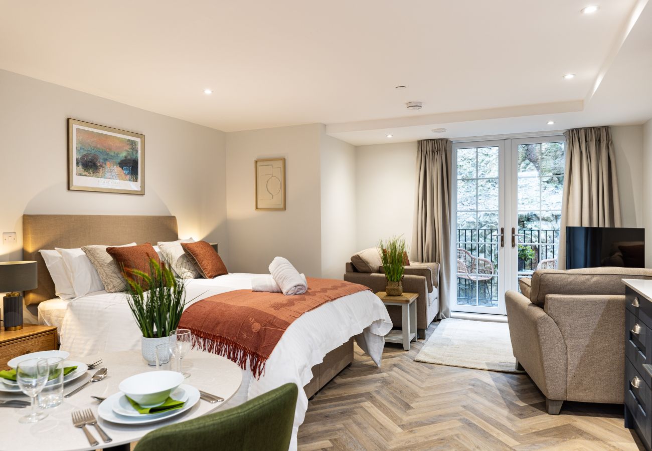 Image showing the combined living, dining, and sleeping space inside Studio Apartment 18