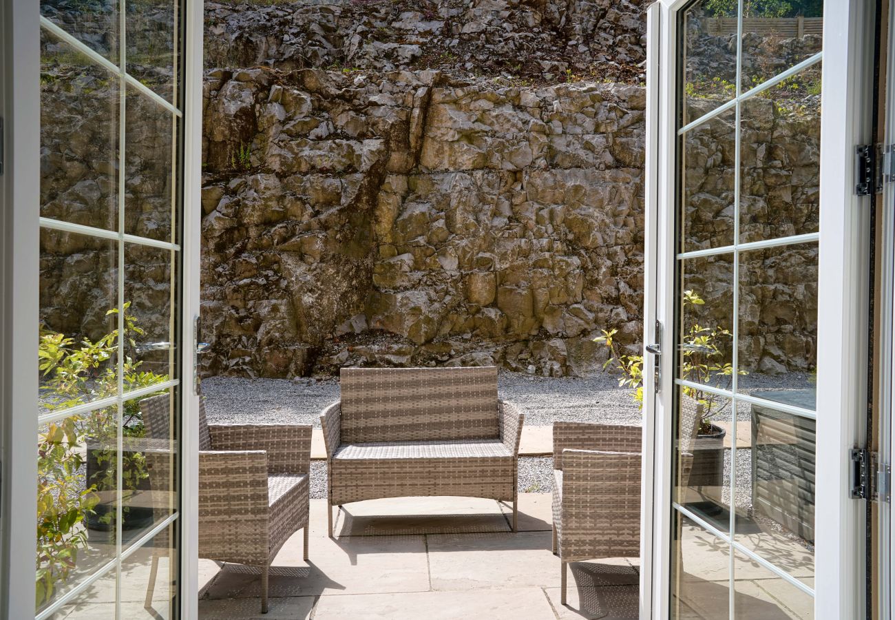 French doors opening out to the patio with outdoor seating at Rock Mill Studio Apartment 9