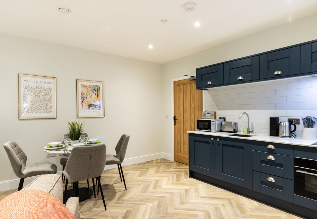 Image showing the fully equipped kitchen and dining area for 4 inside Rock Mill Apartment 4
