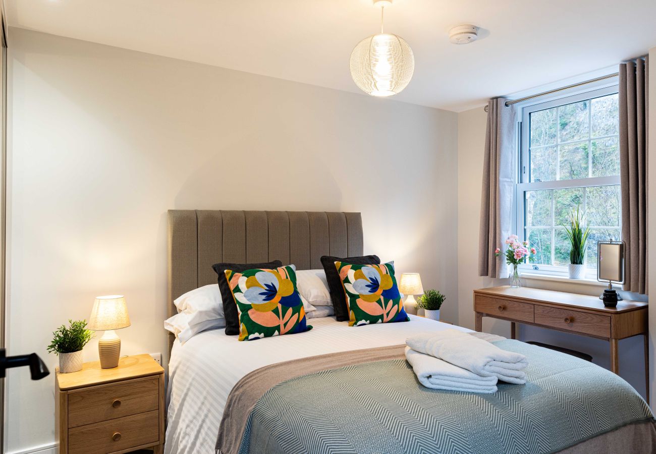 Image of the bedroom with desk space inside Rock mill apartment 32