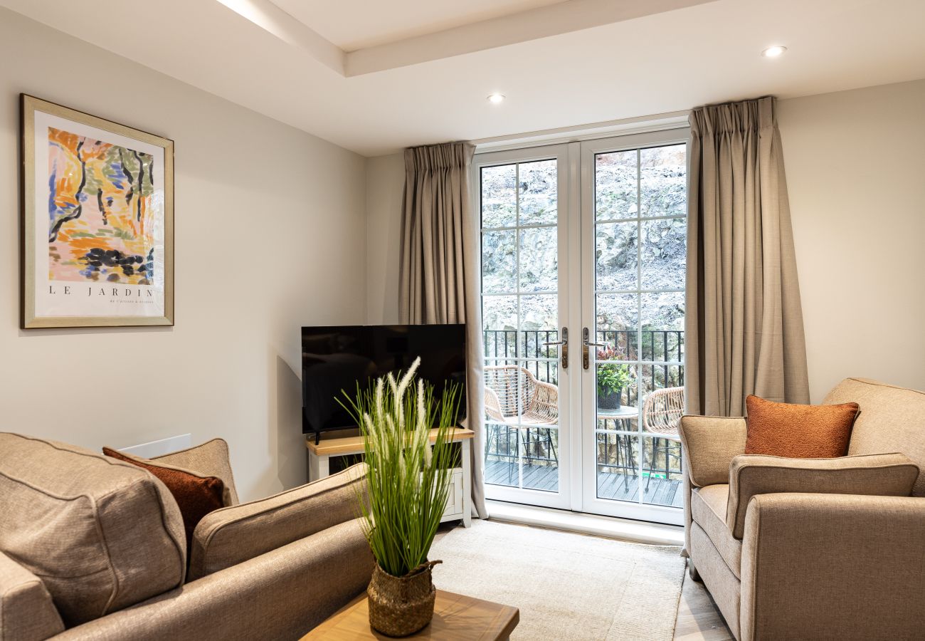 Studio apartment 16 at Rock Mill has a comfortable living area with a smart TV