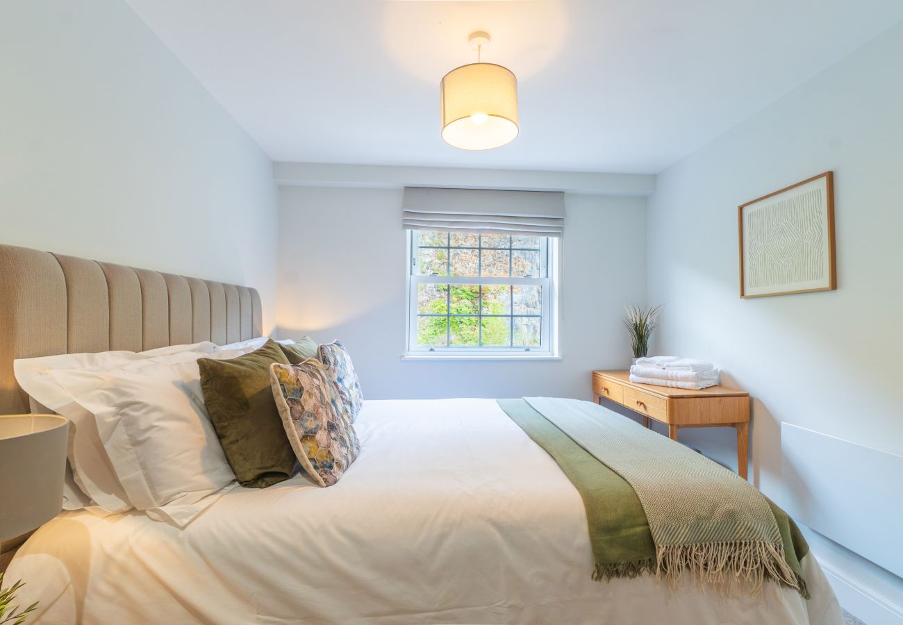 Image shows spacious bedroom with king size double bed