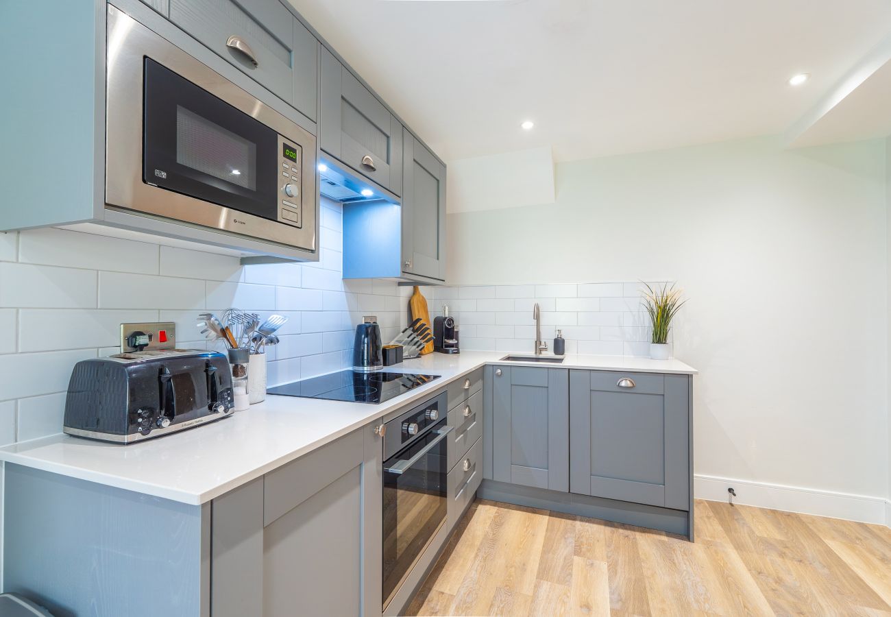 Images shows a modern grey fitted kitchen in Apartment 41 at Rock Mill 