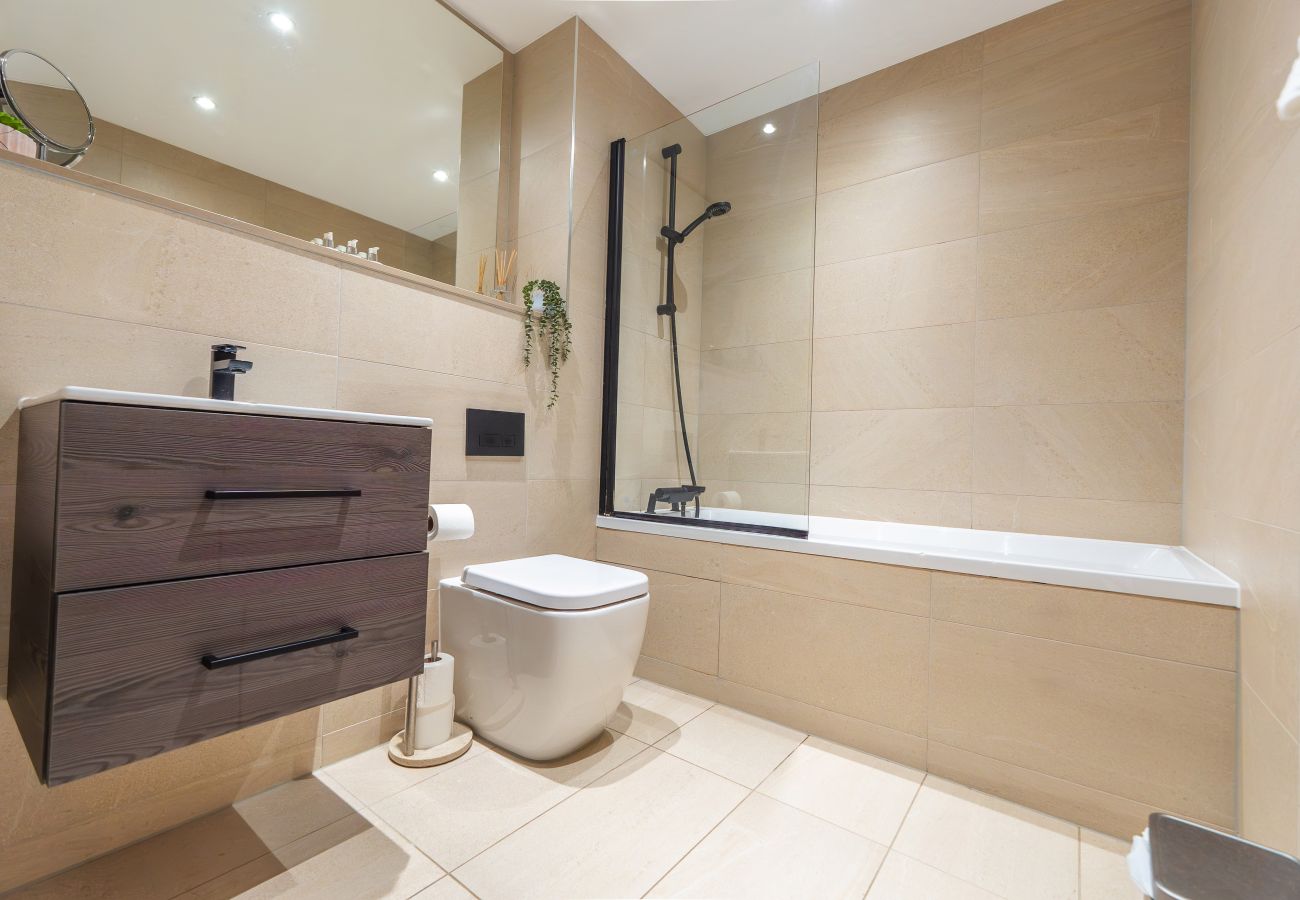 Images shows bathroom in Apartment 41 with bath, shower over the bath, wc and wash basin